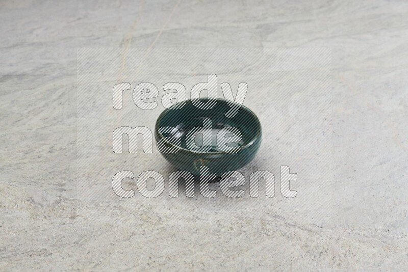 A multicolored pottery bowl on grey marble background