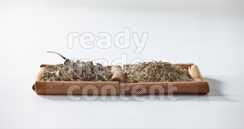 2 squares of cinnamon sticks full of dried basil and cumin on white flooring