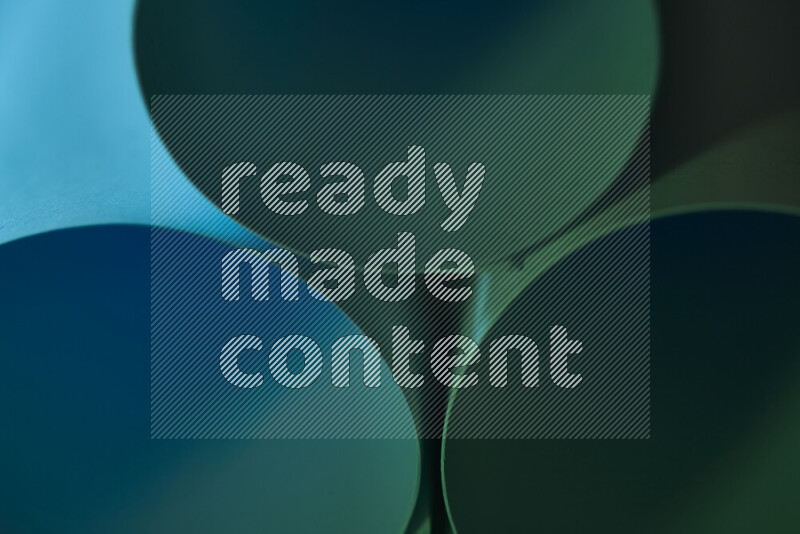 The image shows an abstract paper art with circular shapes in varying shades of green and blue