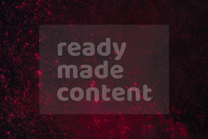 Red powder explosion on black background