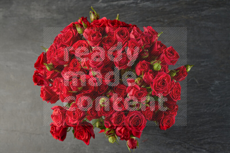 A luxurious bouquet of red roses on black marble background