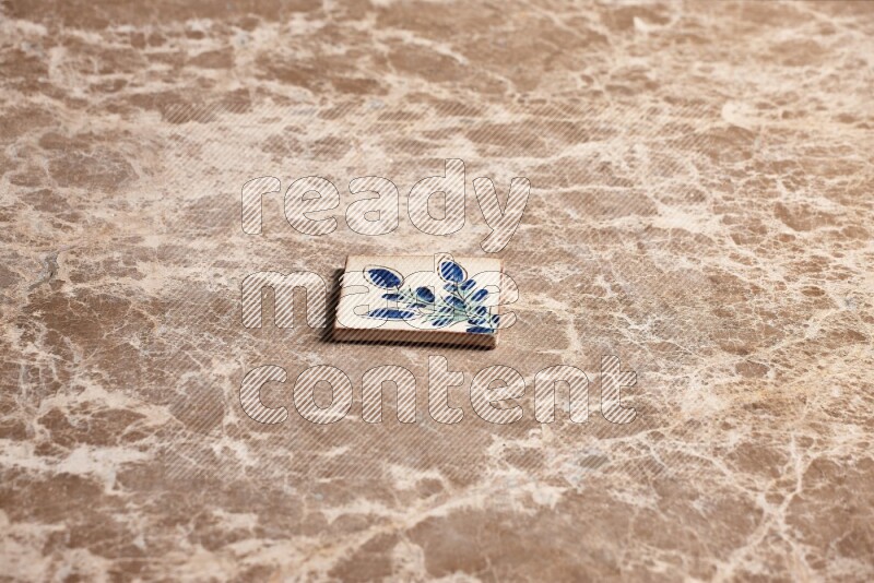 A decorative coaster on beige marble background