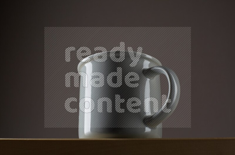 Low angle shot of a grey cup on grey background
