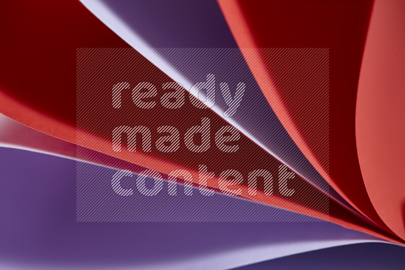 An abstract art showing purple and red paper sheets arranged in an overlapping curves