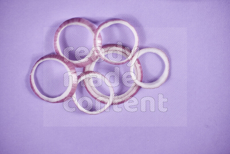 Red onions rings on purple background