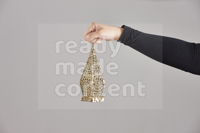 A woman in black abaya holding different ramadan lanterns in different positions