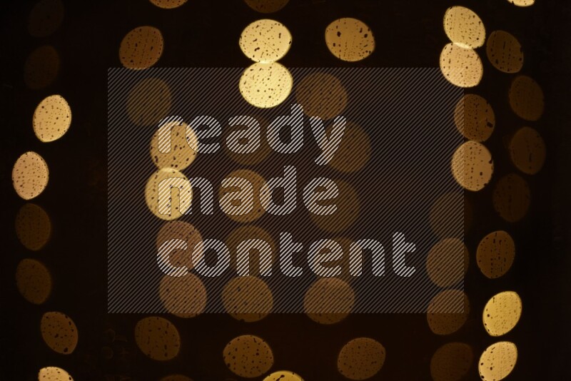 Bokeh light in yellow with water drops