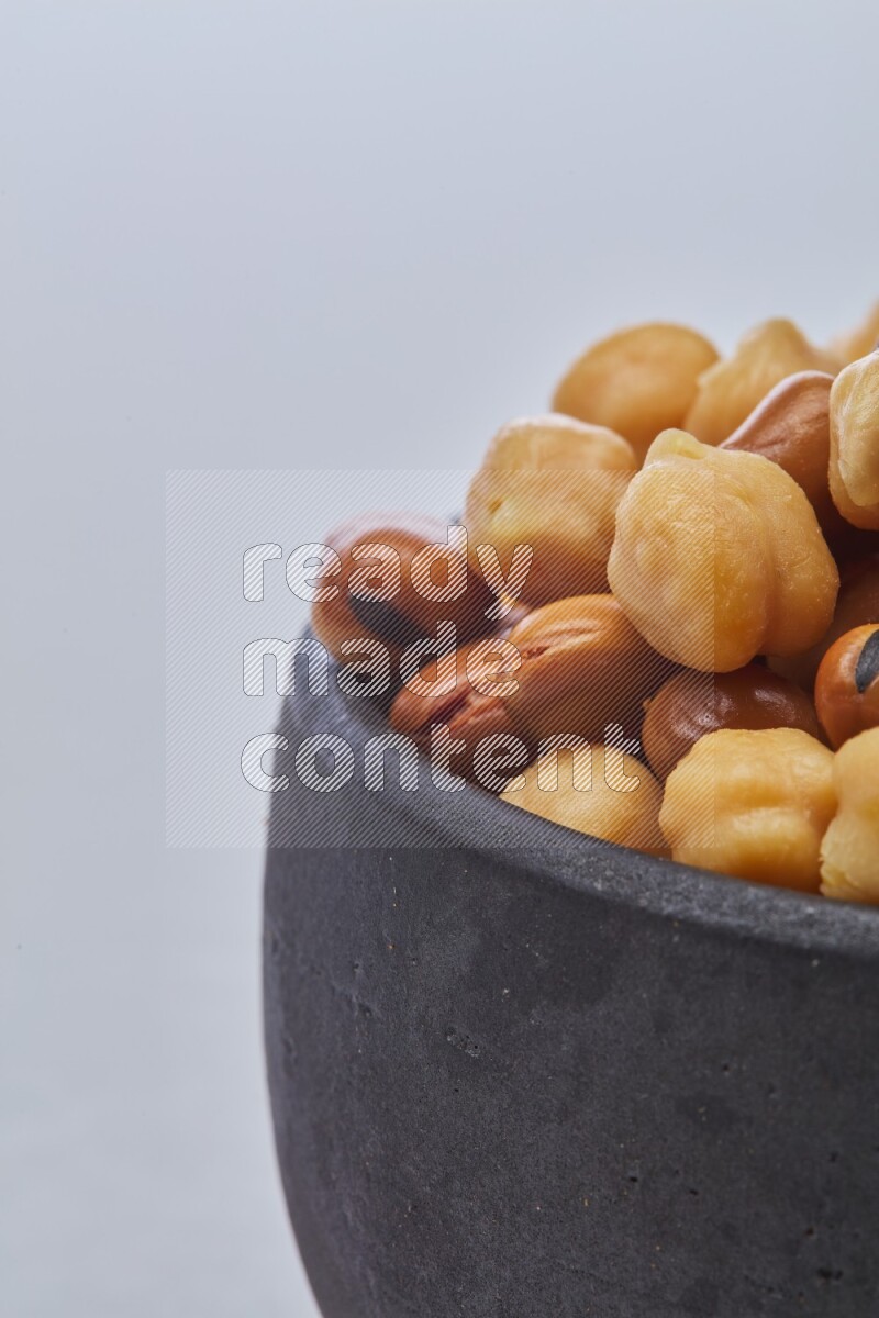 Close up shot of cooked fava beans (foul) & chickpeas on white background