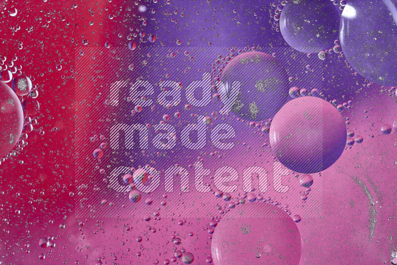 Close-ups of abstract oil bubbles on water surface in shades of red, purple and pink