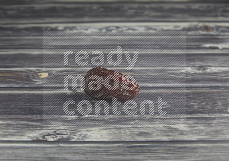 one madjoul date on a wooden grey background