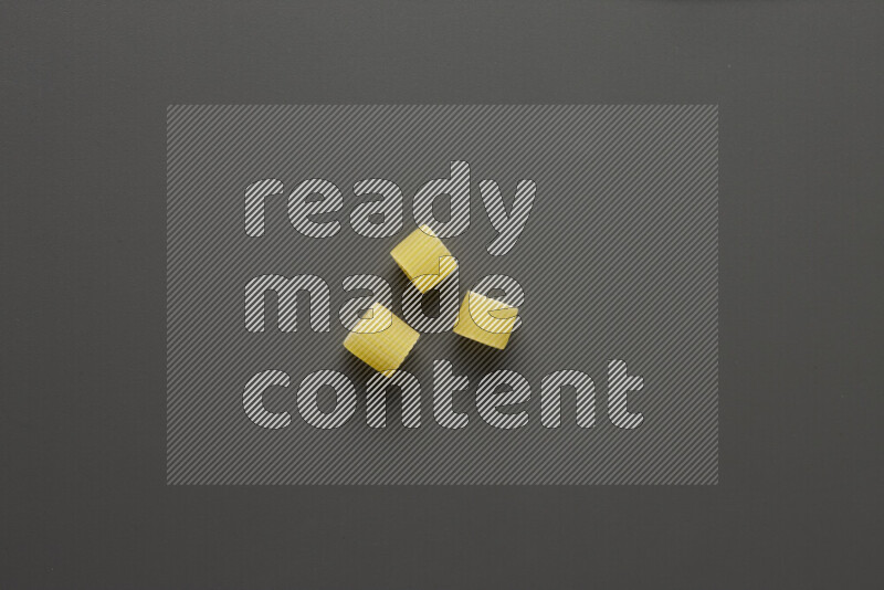 Big rings pasta on grey background