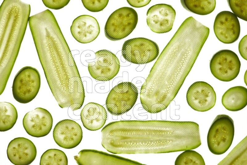 Zucchini slices on illuminated white background