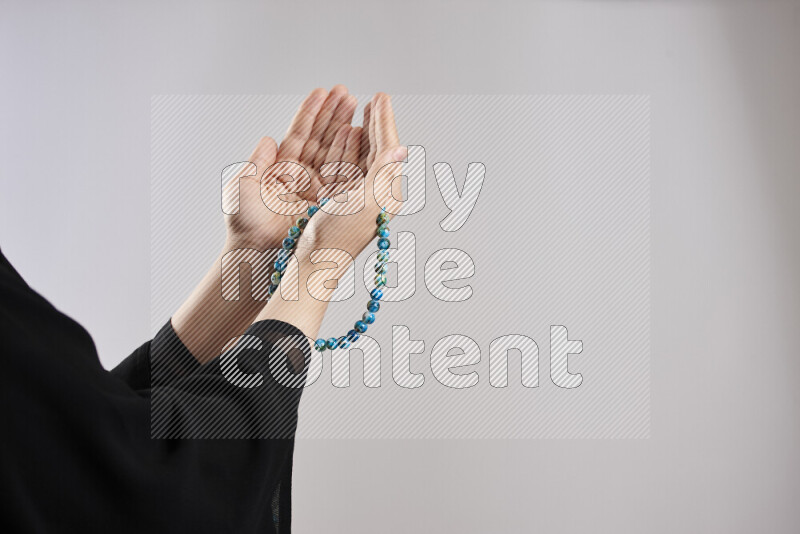 Woman hands holding praying beads (sebha) in different positions