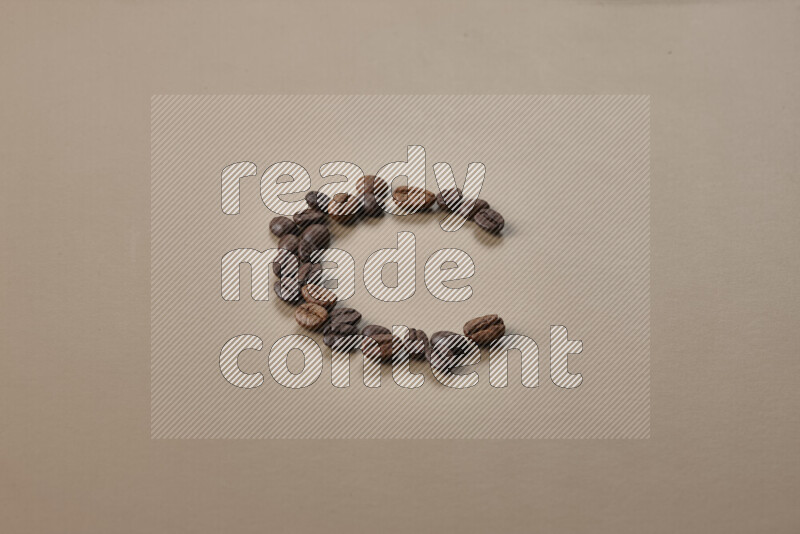 Roasted coffee beans on beige background