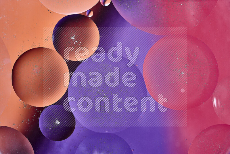 Close-ups of abstract oil bubbles on water surface in shades of red, orange and purple