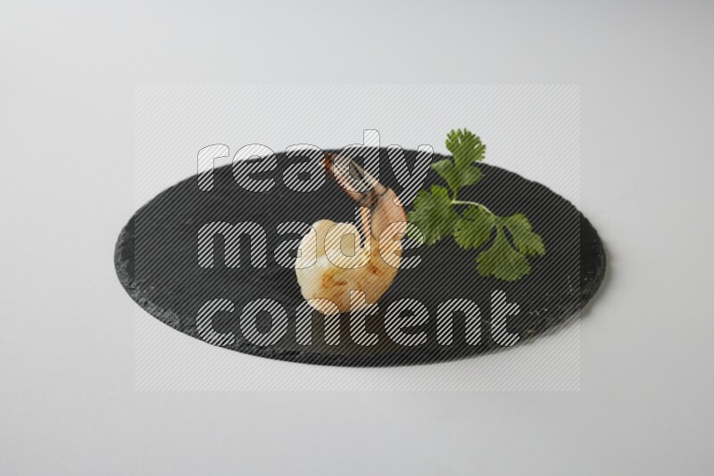 one  grilled shrimp  on a black slate direct  on a white back ground
