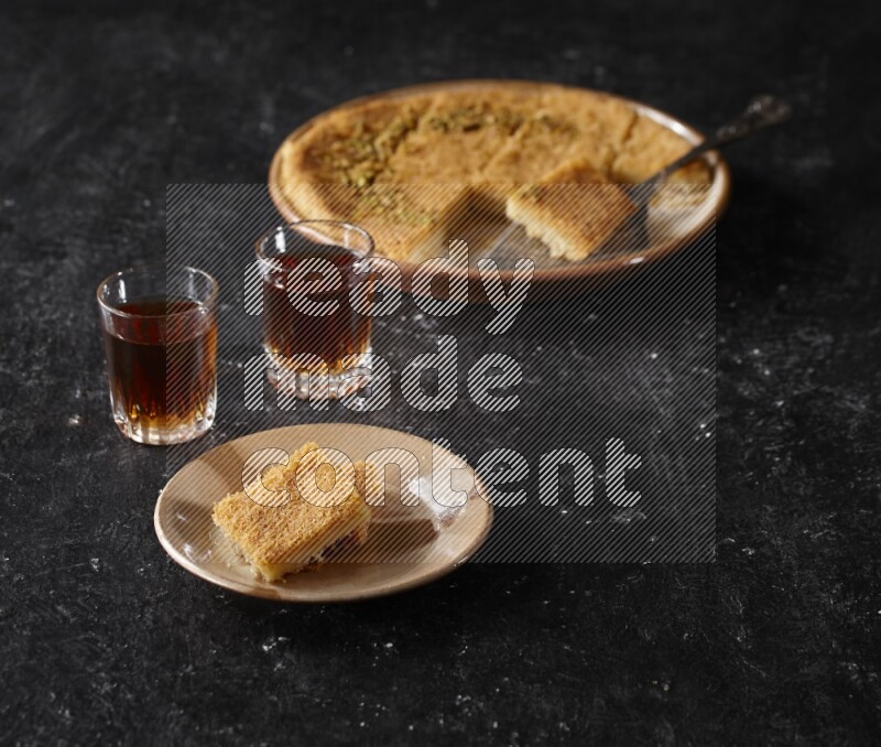 konafa with tea in a dark setup