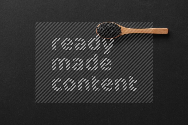 wooden spoons filled with white peppers, mustard seeds, black seeds, garden cress, cumin and flax on black flooring