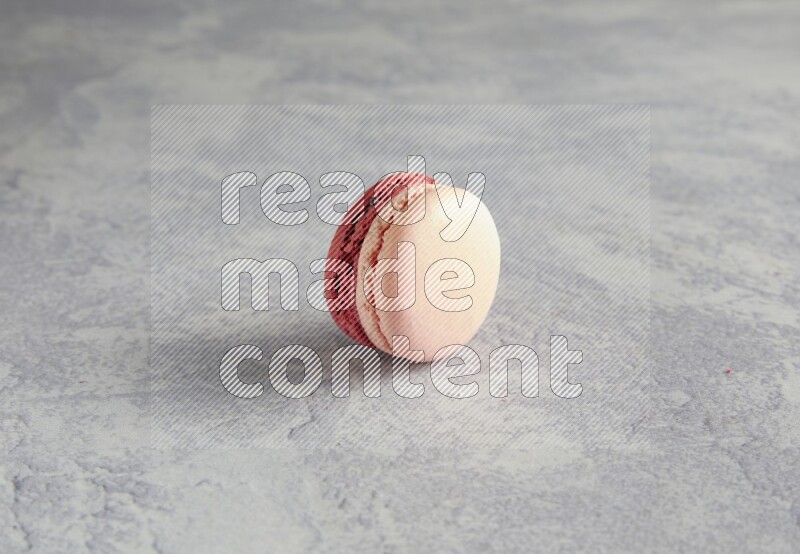 45º Shot of Pink Litchi Raspberry macaron on white  marble background