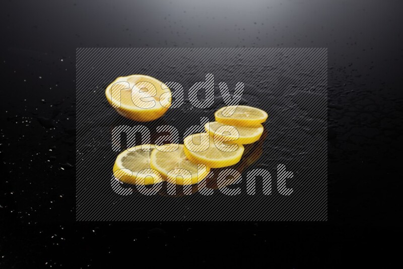 Lemon slices with water drops, and droplets on black background