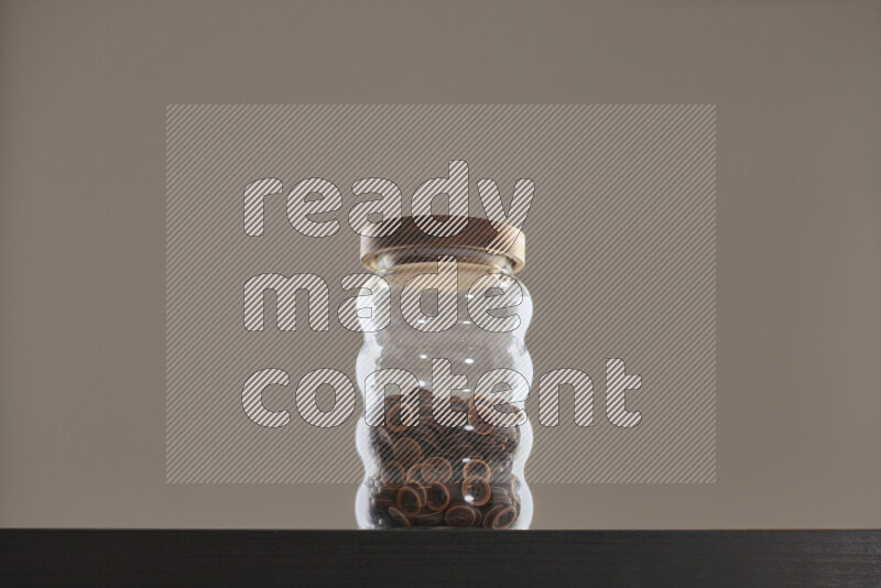Buttons in a glass jar on black background