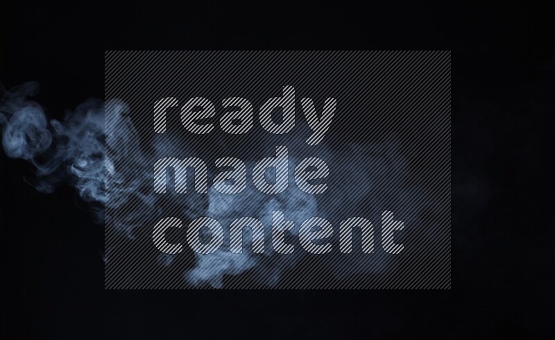 Heavy smoke in blue isolated on black background