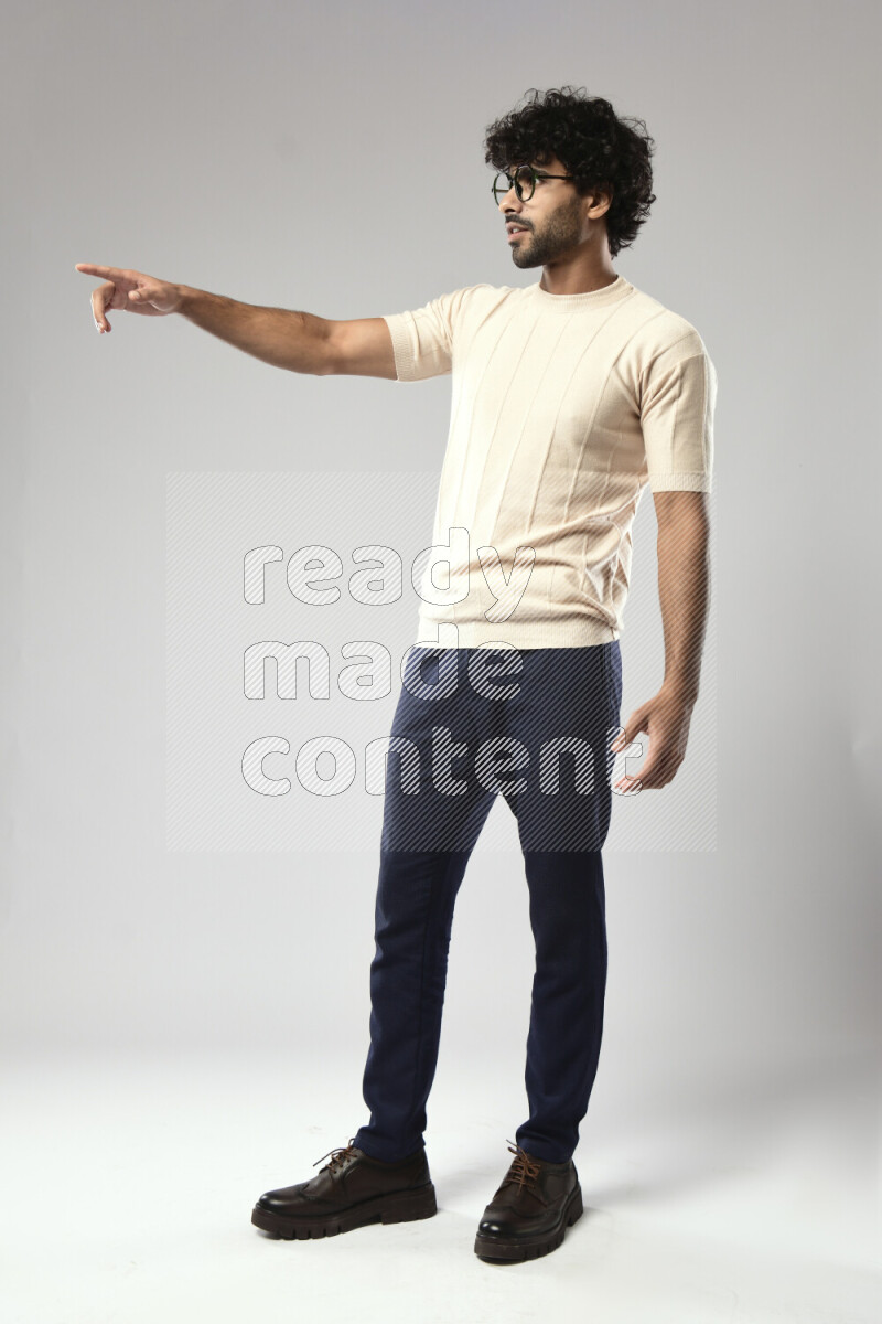 A man wearing casual standing and making a hand gesture on white background