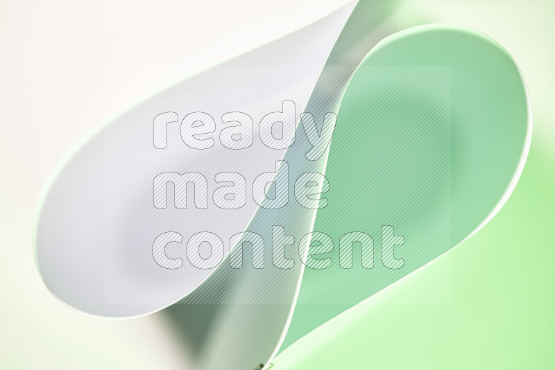 An abstract art of paper folded into smooth curves in white and green gradients
