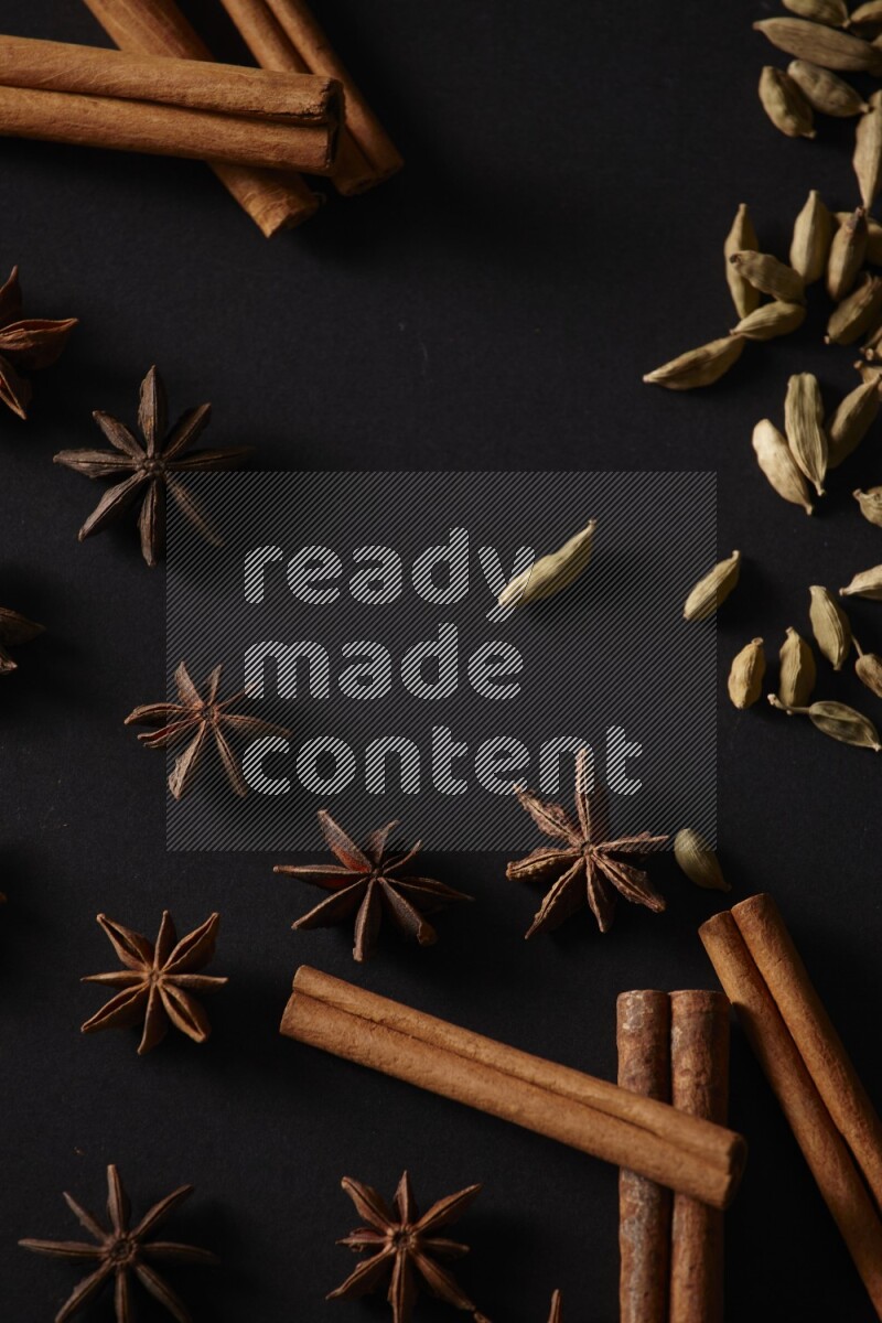 Cinnamon Sticks, Cardamom and star anise on a black background