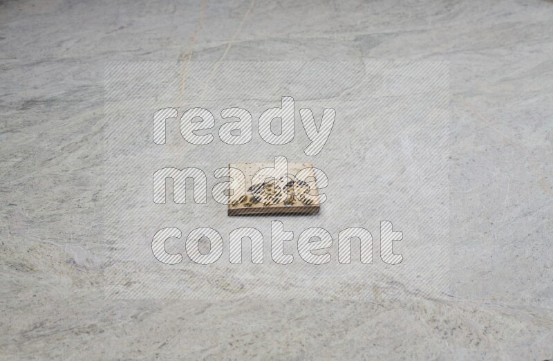 Top view shot of a pottery coaster\ tile on beige marble flooring