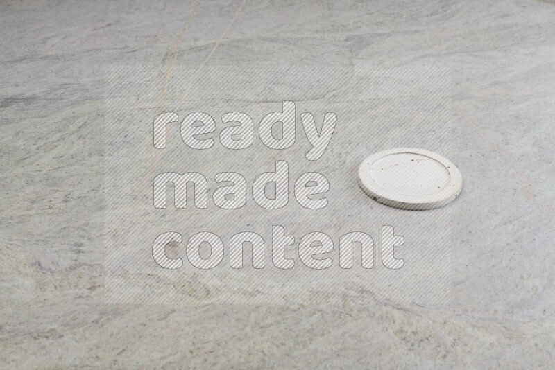 A white pottery bowl's lid on grey marble background