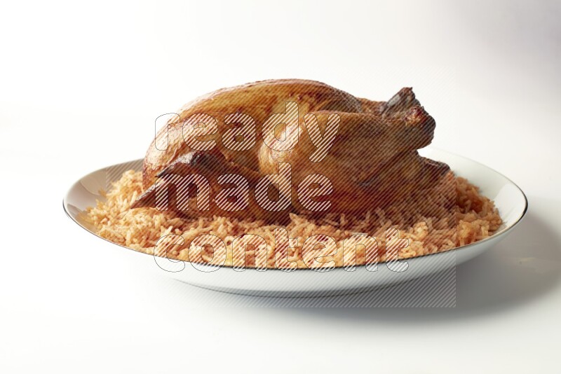 red basmati Rice with whole roasted chicken on a white plate with a silver rim direct on white background