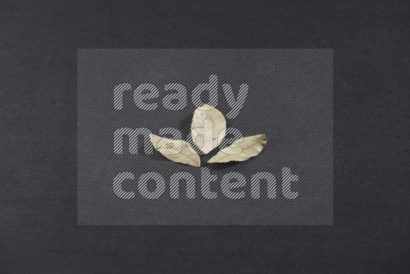 Dried bay leaves on black flooring