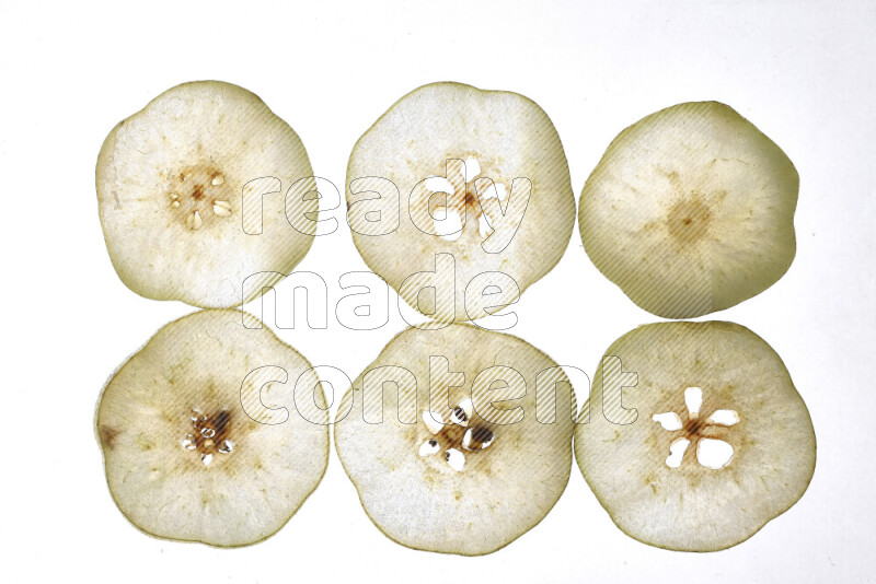 Pear slices on illuminated white background