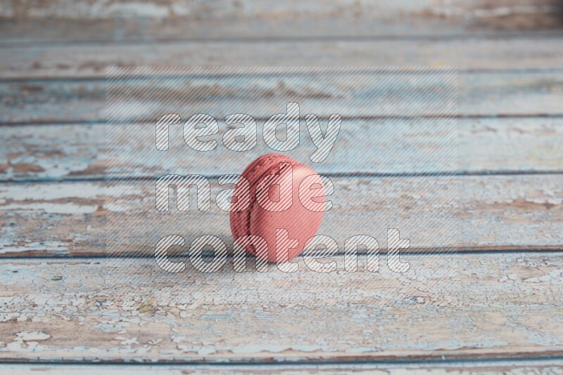45º Shot of Pink Raspberry macaron on light blue wooden background