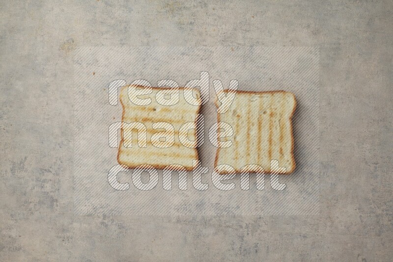 Toasted white Toast slices on a light blue textured background