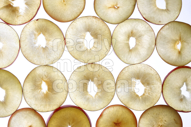Peach slices on illuminated white background