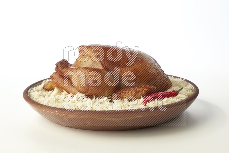 white  basmati Rice with  whole roasted chicken    on a pottery plate  direct  on white background