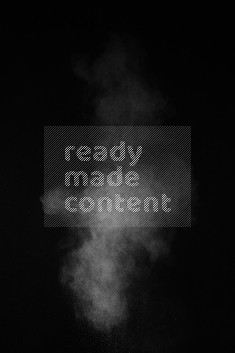 A side view of white powder explosion on black background