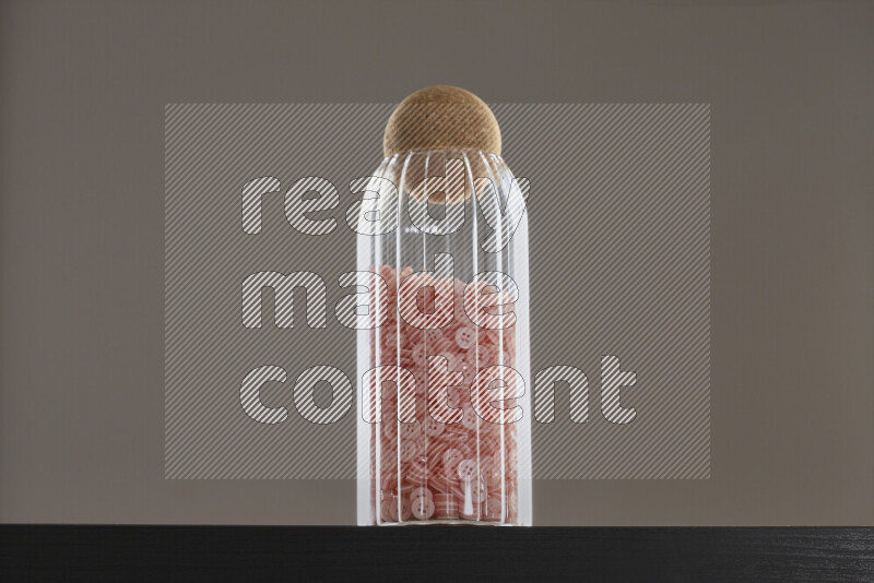 Buttons in a glass jar on black background