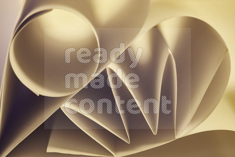 An artistic display of paper folds creating a harmonious blend of geometric shapes, highlighted by soft lighting in warm tones