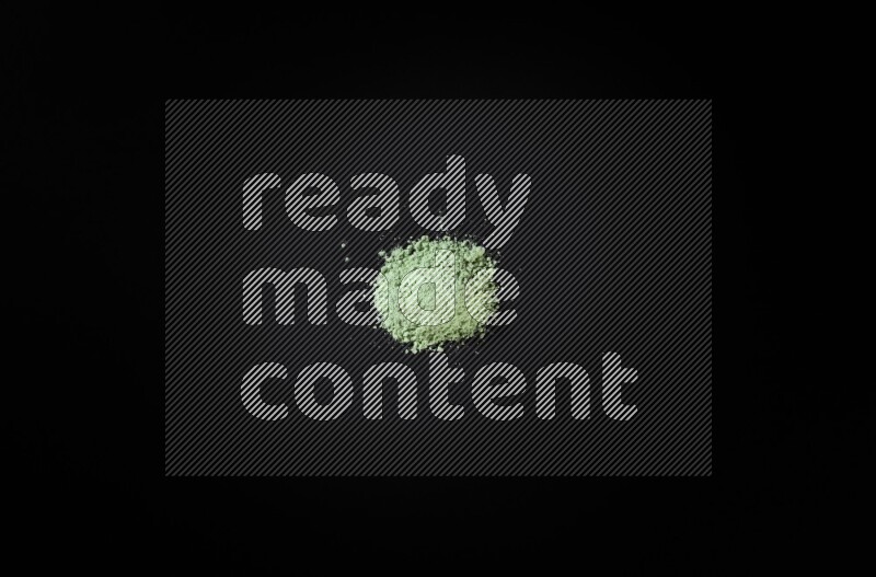 Green powder on black background