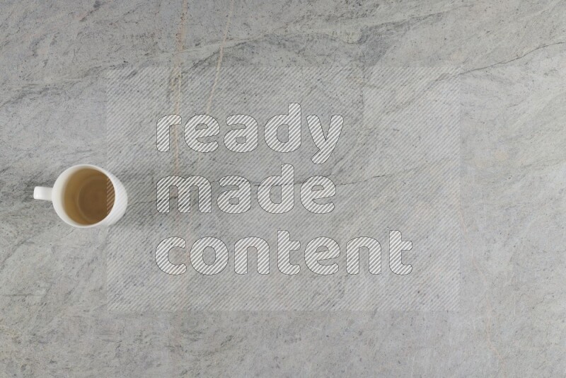 A multicolored pottery Cup on grey marble background