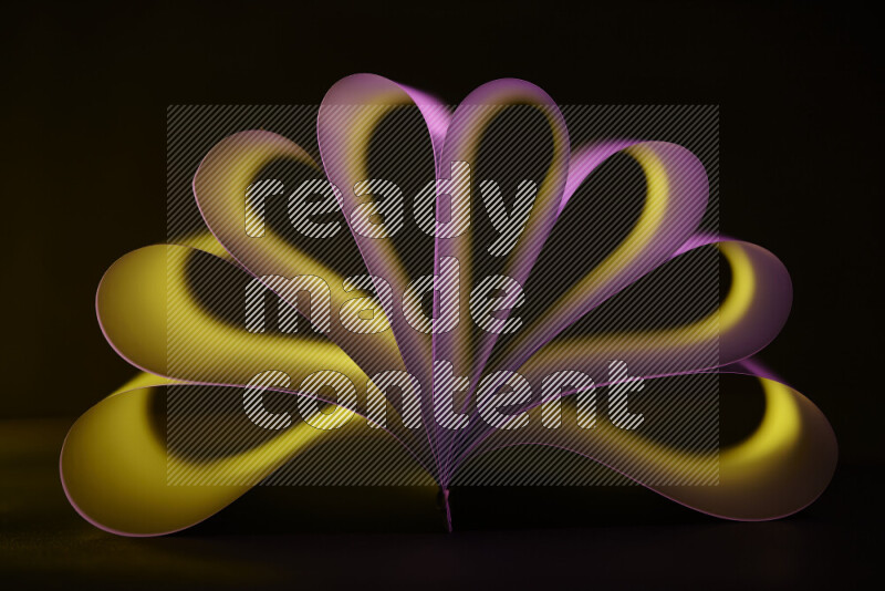 An abstract art piece displaying smooth curves in yellow and pink gradients created by colored light