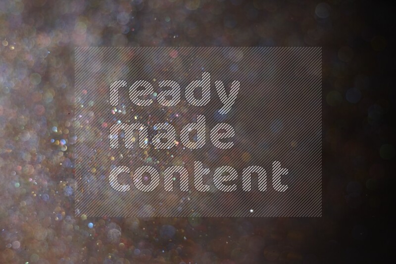 Multicolored glitter powder isolated on black background