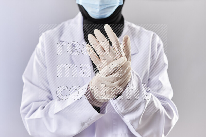 Female doctor wearing an abaya and medical attire in different positions