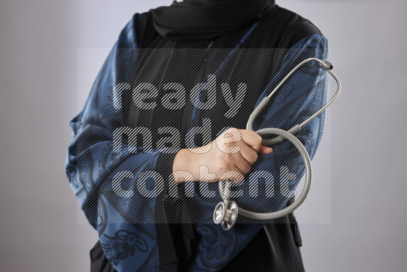 Female doctor wearing an abaya and medical attire in different positions