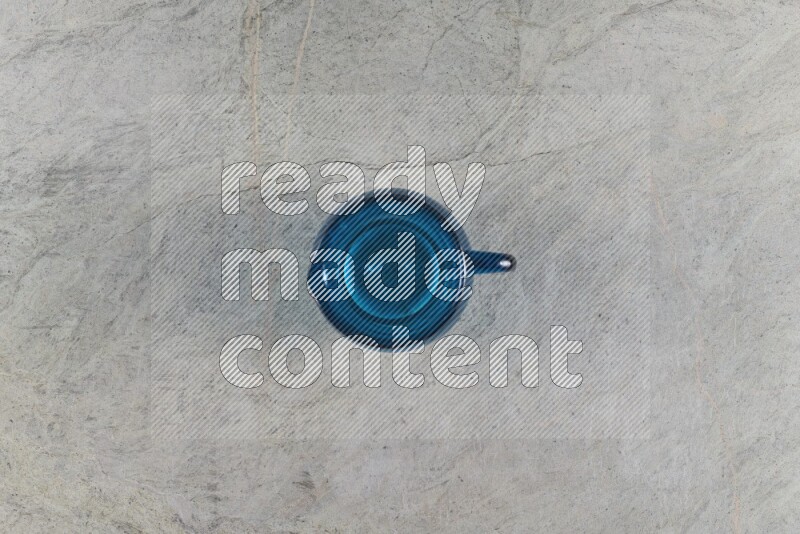 A colored glass jug on grey marble background