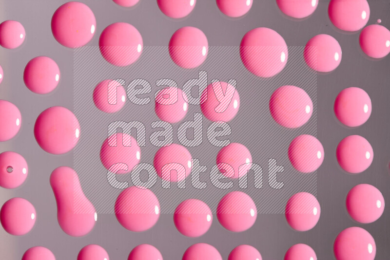Close-ups of abstract pink paint droplets on the surface