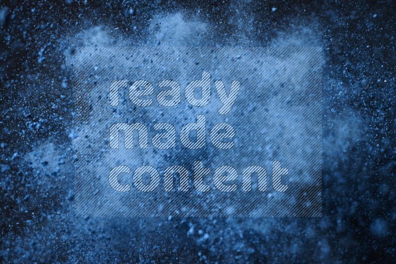 Blue powder explosion on black background